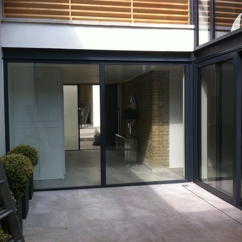 Floor-to-ceiling sliding doors opening to courtyard in Grove Park