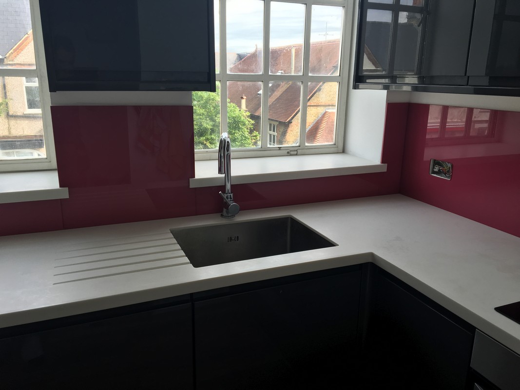 Deep plum coloured glass splashback in modern Grove Park kitchen